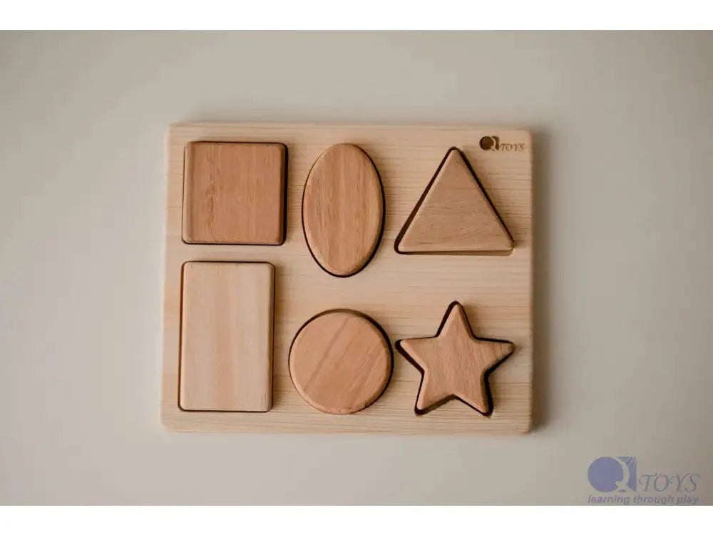 Wooden shape sorter puzzle with basic geometric forms.