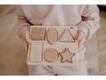 Wooden shape sorter puzzle with various geometric forms.