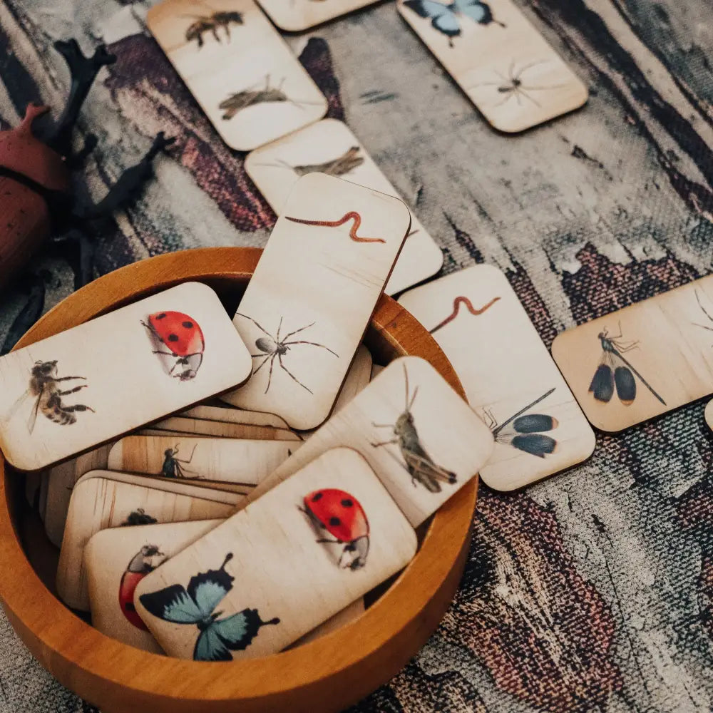 Wooden tiles with illustrations of various insects and animals.