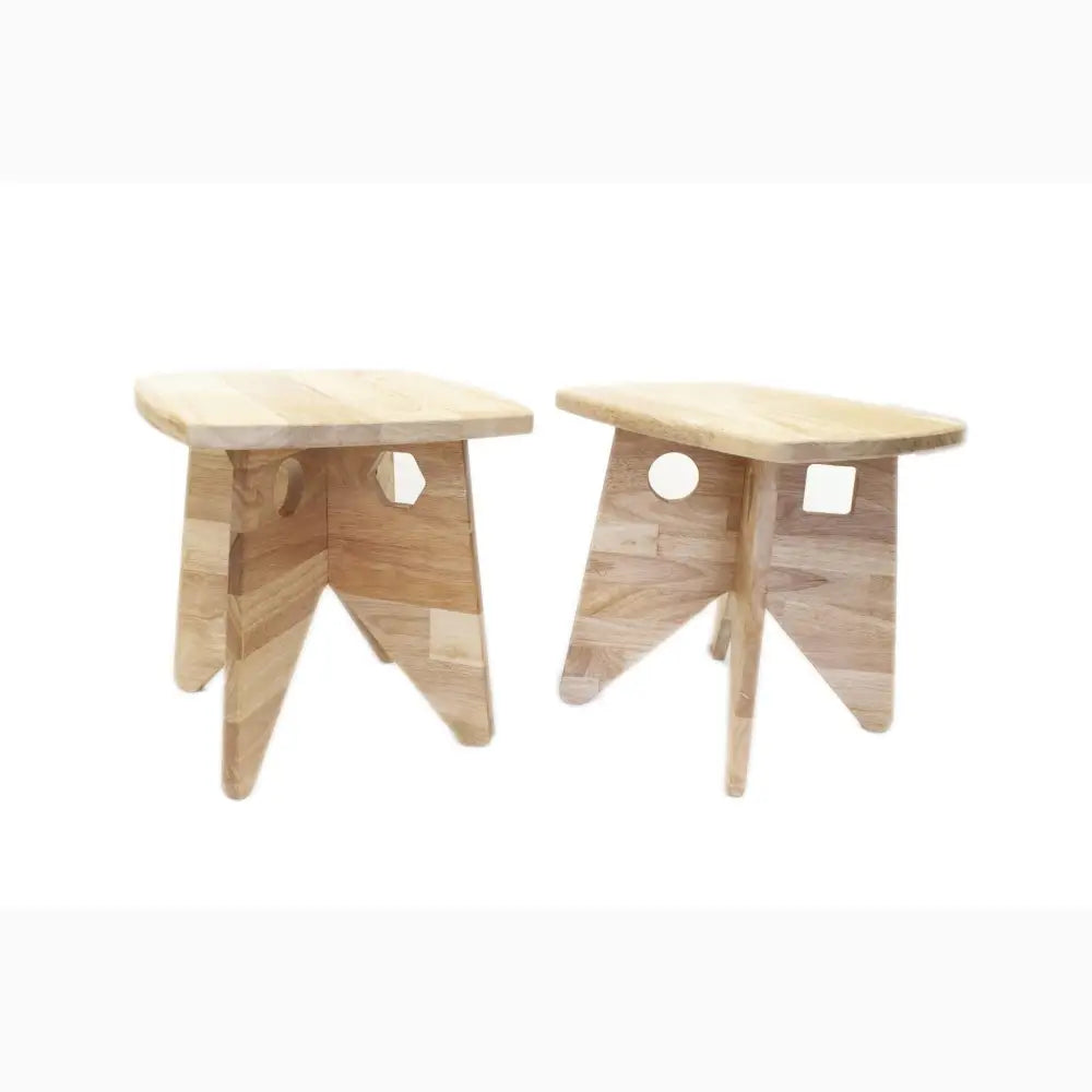 Two wooden stools with simple, angular designs and circular cutouts in their sides.