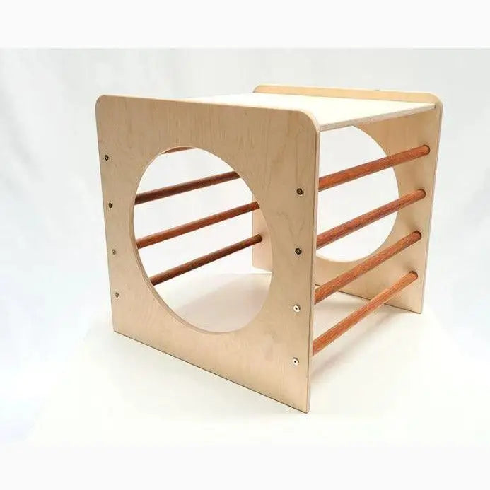 Wooden cube-shaped structure with circular cutouts and horizontal bars.