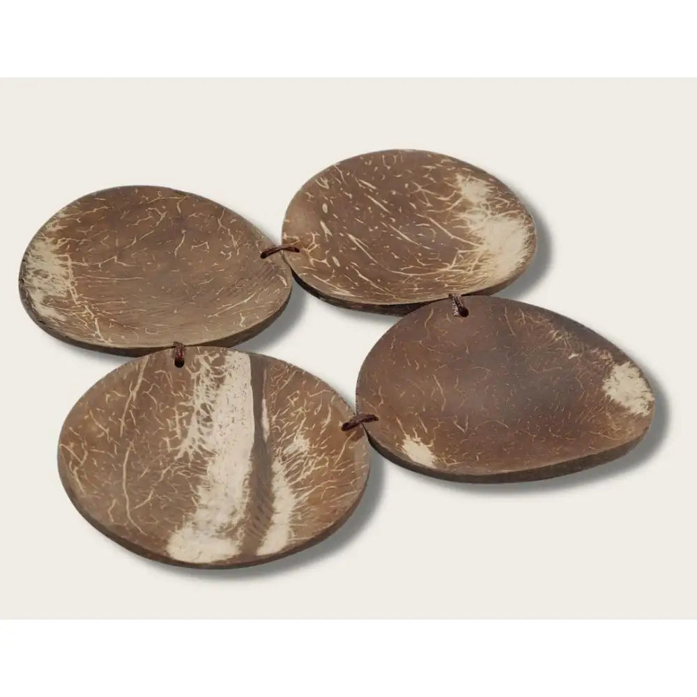 Coconut shell pieces shaped into flat, oval discs.