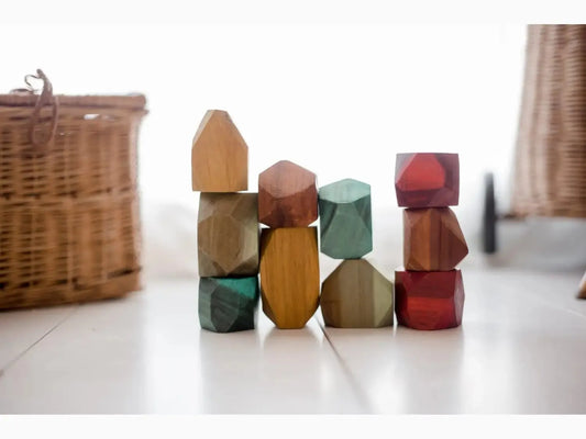 Colorful wooden building blocks in various geometric shapes stacked together.