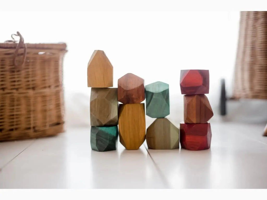 Colorful wooden building blocks in various geometric shapes stacked together.