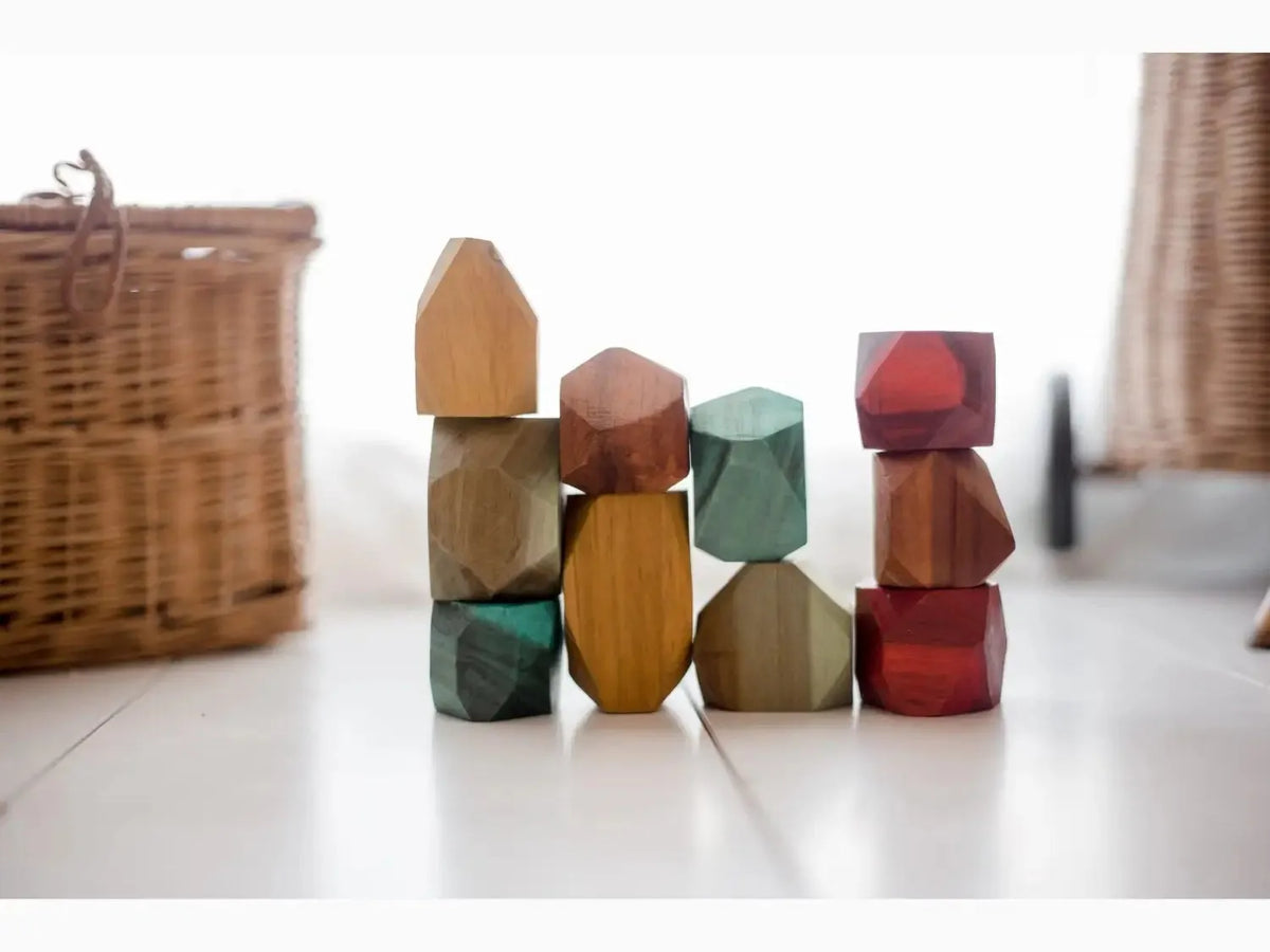 Colorful wooden building blocks in various geometric shapes stacked together.