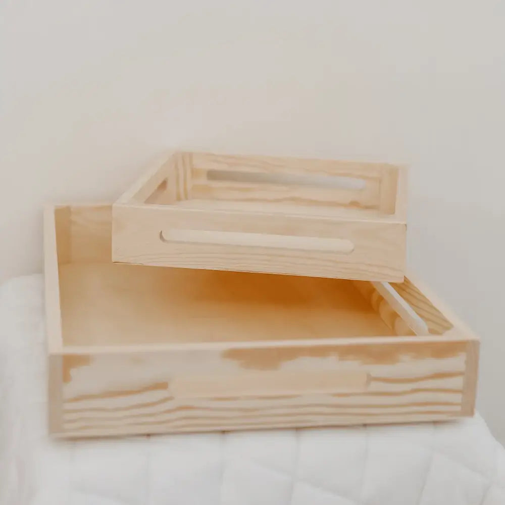 Two stacked wooden trays or shallow boxes with open tops.