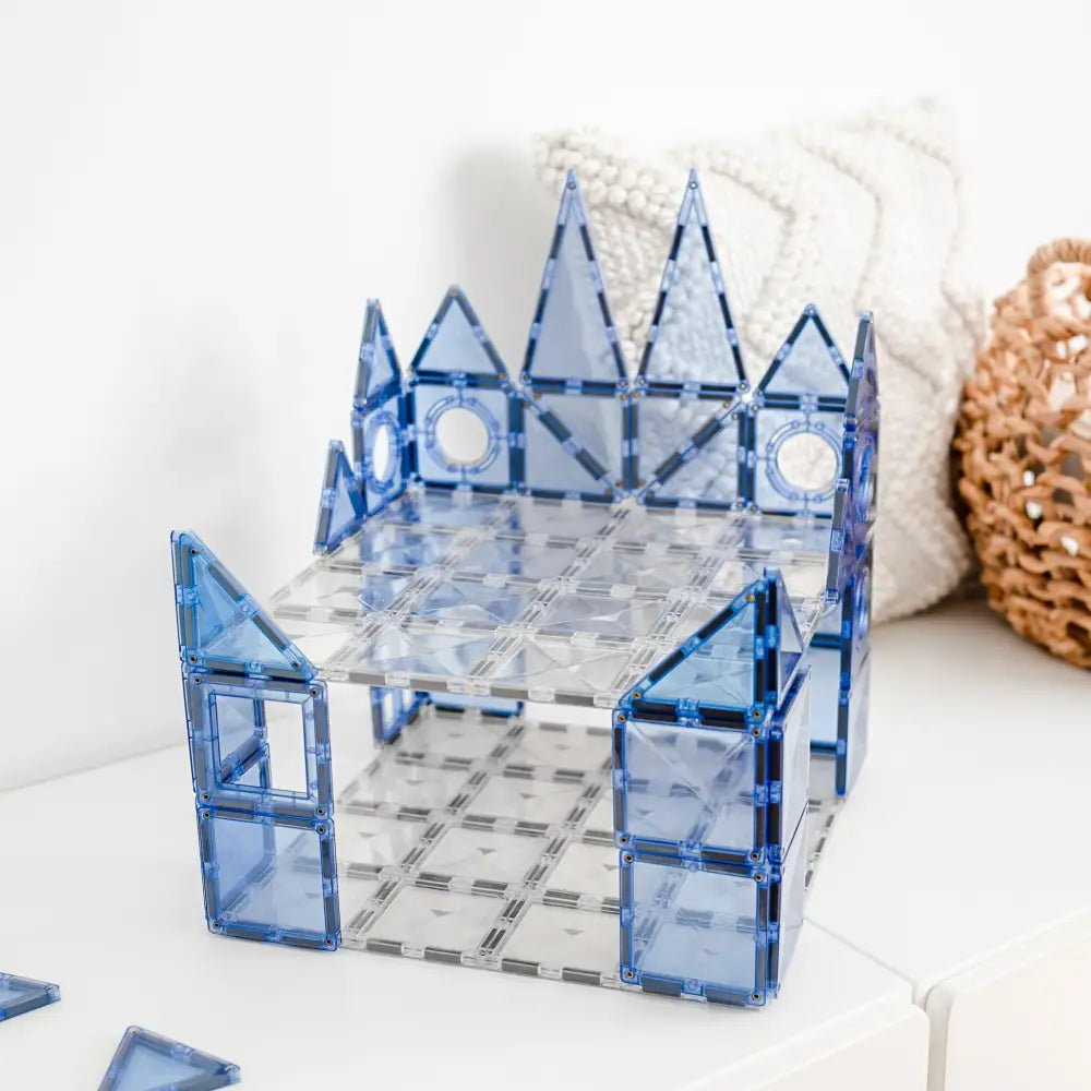 Blue translucent building-block structure resembling a miniature castle or fortress.