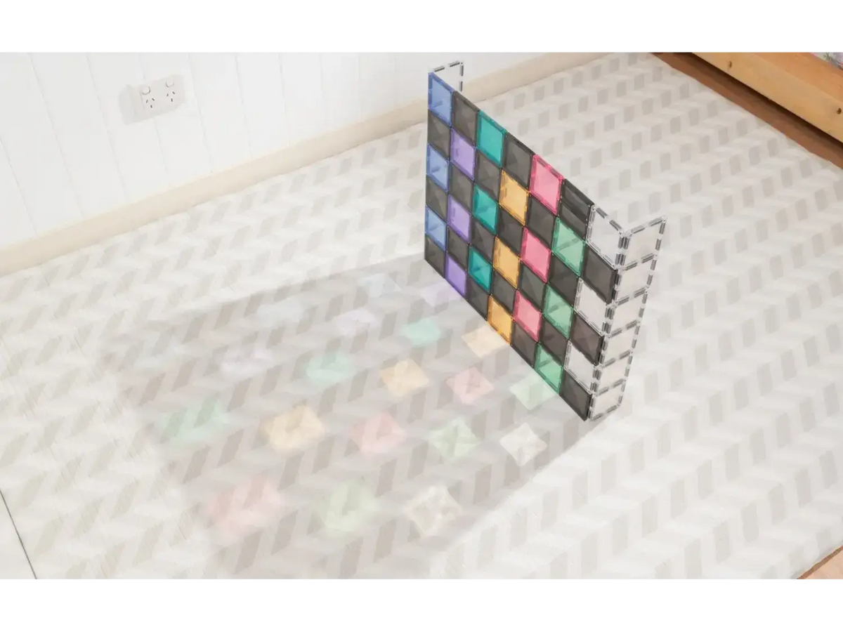 Colorful geometric grid structure casting a rainbow-like shadow on a tiled floor.
