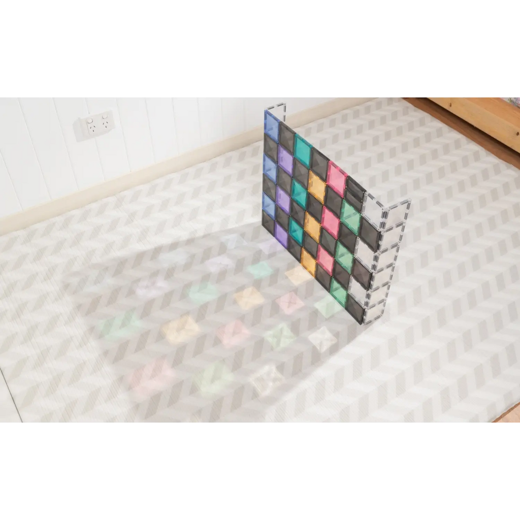 Colorful geometric grid structure casting a rainbow-like shadow on a tiled floor.