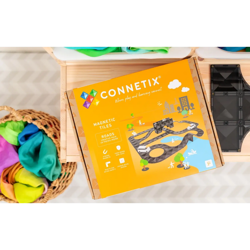 Connetix magnetic tile toy set box with colorful graphics depicting construction scenes.