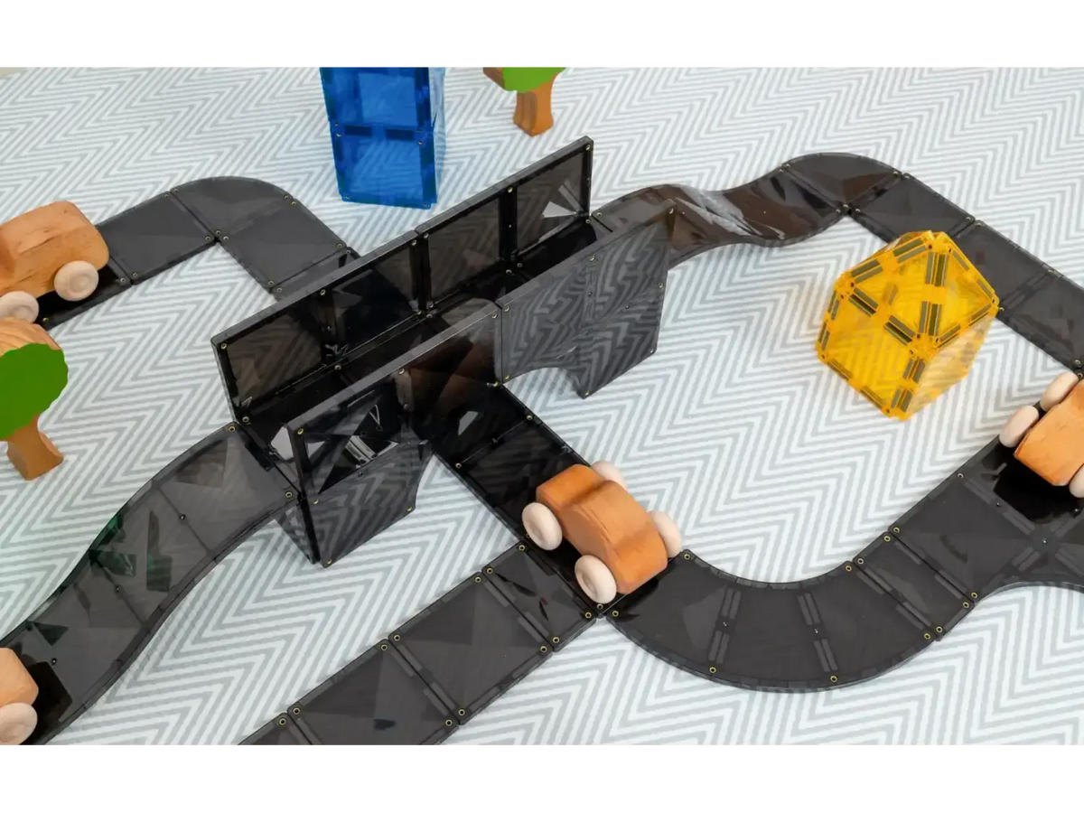 Toy road or racetrack with colorful vehicles and a bridge.