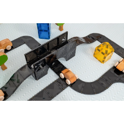 Toy road or racetrack with colorful vehicles and a bridge.