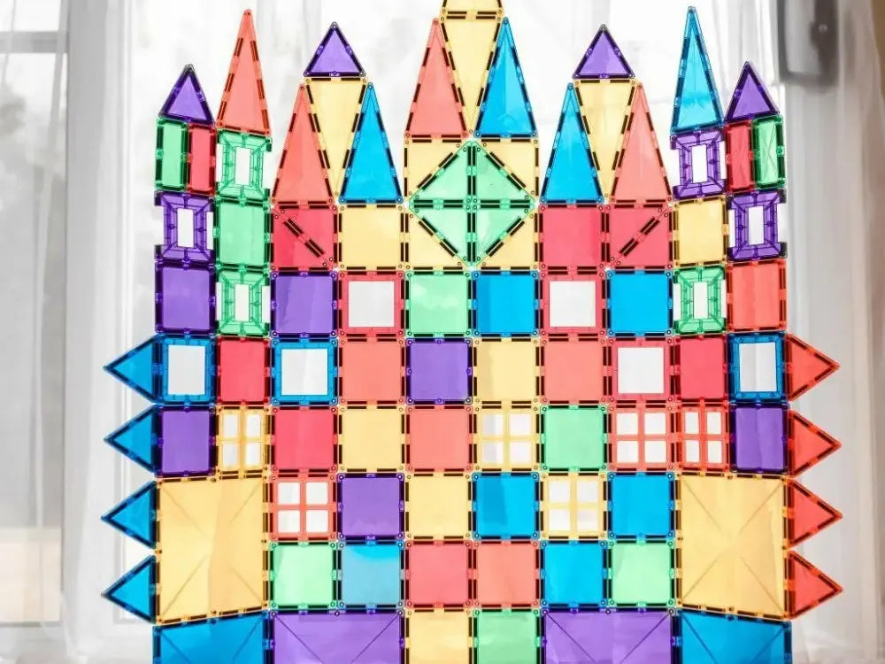 Colorful castle-like structure made of geometric magnetic tiles.