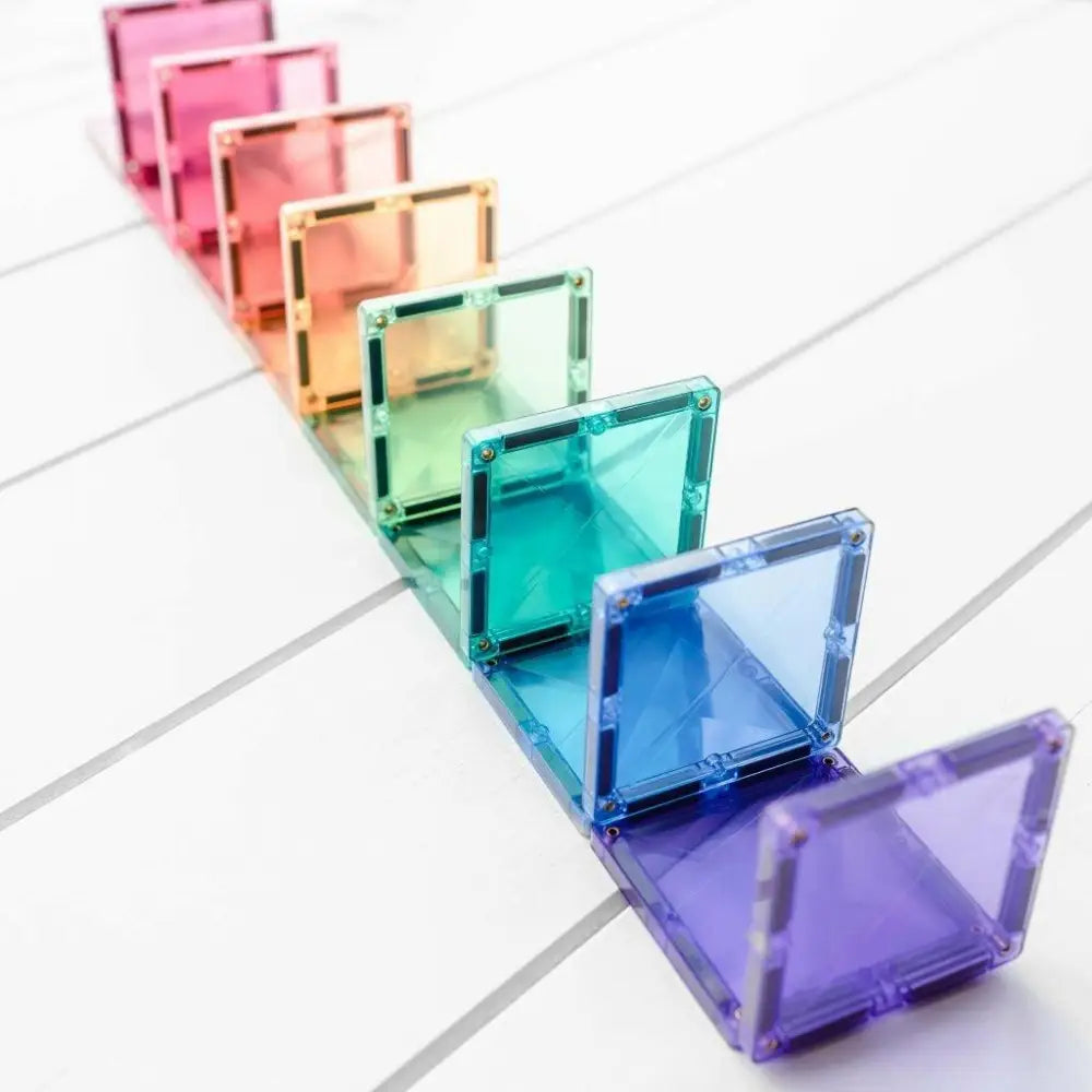 Rainbow-colored, transparent acrylic or glass squares arranged in a diagonal line.