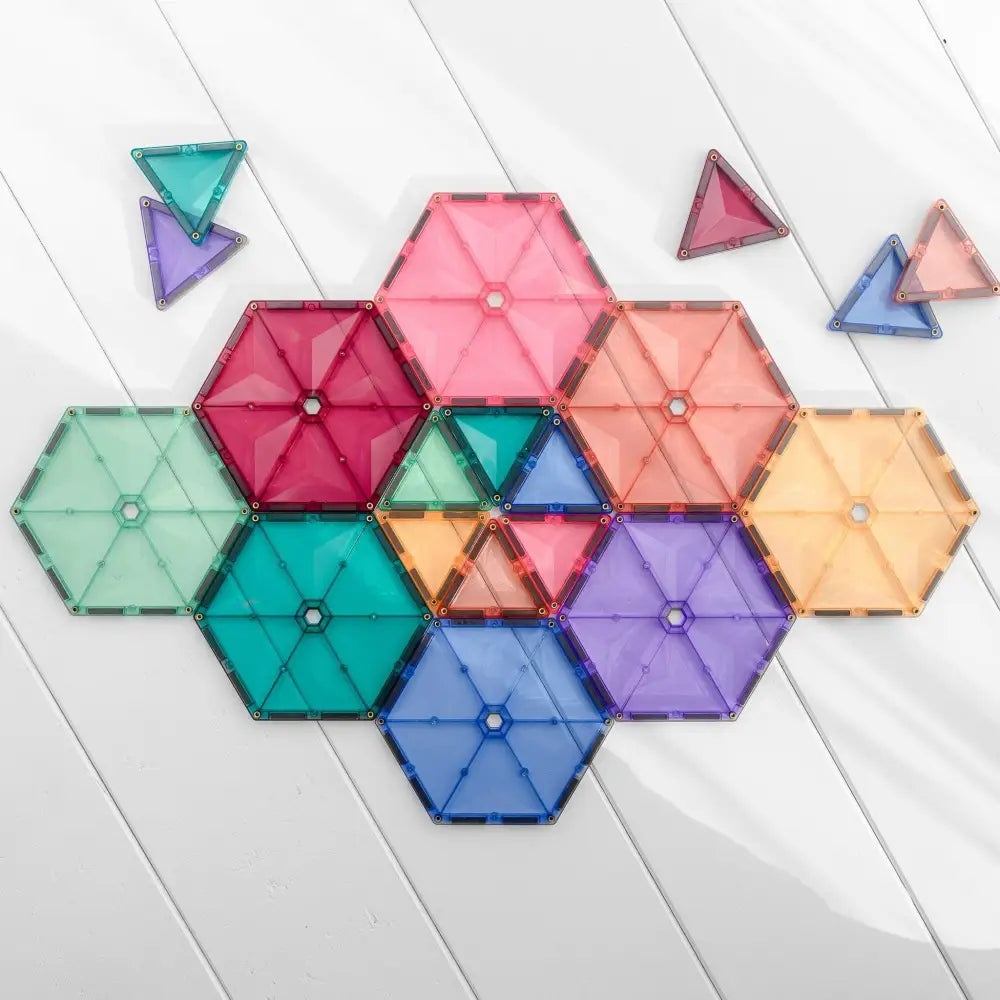 Colorful hexagonal and triangular magnetic tiles arranged in a geometric pattern.