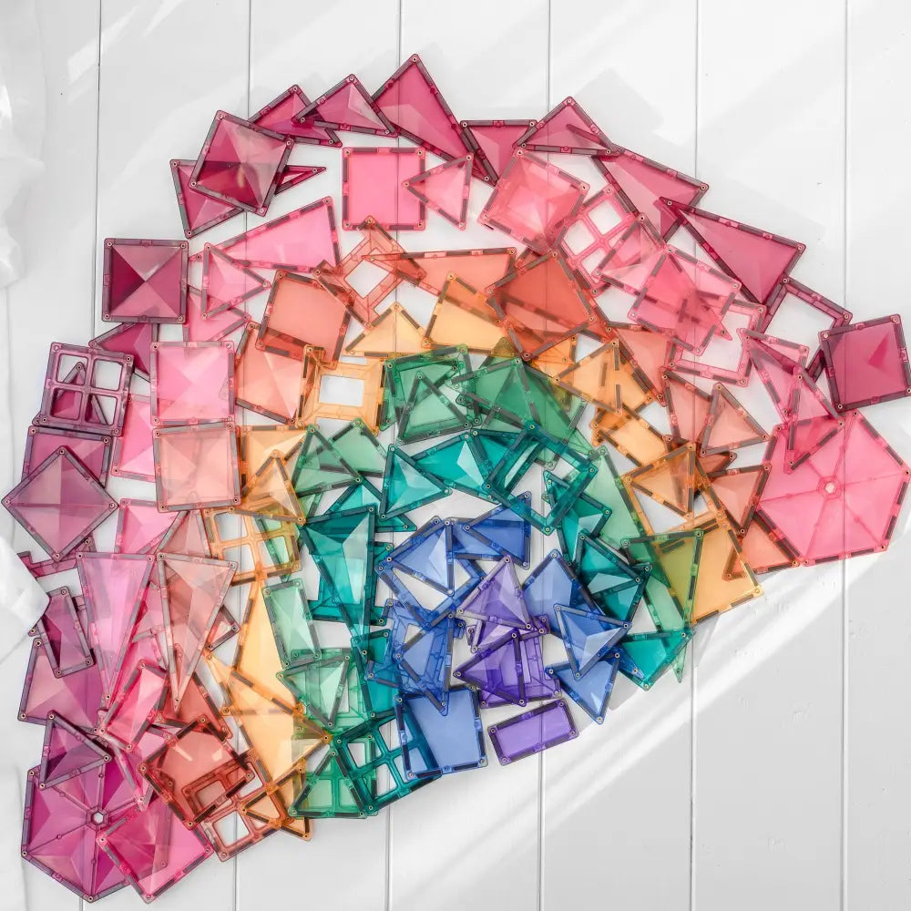 Rainbow-colored arrangement of square paper pieces forming a fan or arc shape.