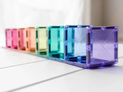 Row of colorful translucent cube-shaped objects arranged in a rainbow spectrum.