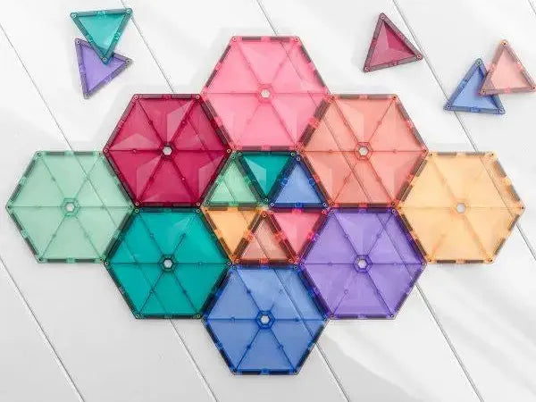 Colorful hexagonal and triangular magnetic tiles arranged in a geometric pattern.