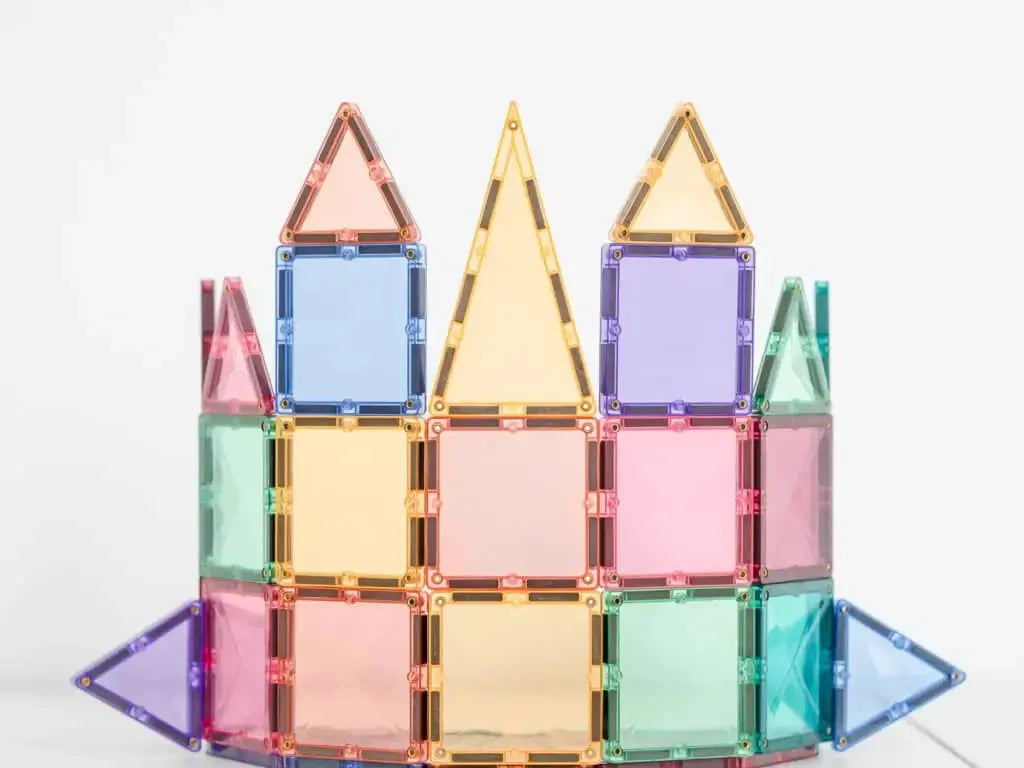 Colorful magnetic building tiles arranged into a castle-like structure.