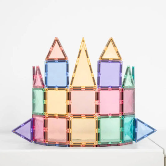 Colorful magnetic building tiles arranged into a castle-like structure.