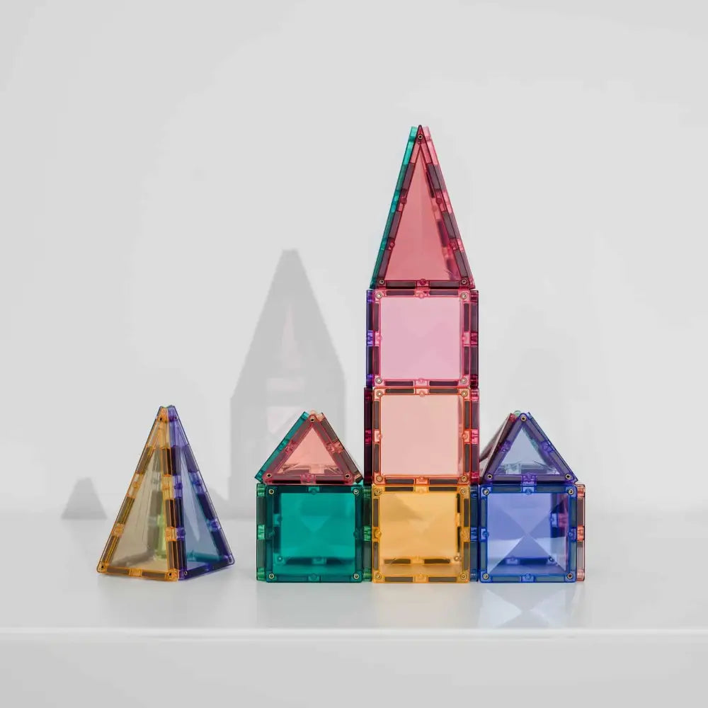 Colorful translucent geometric shapes resembling building blocks or a simplified toy house structure.