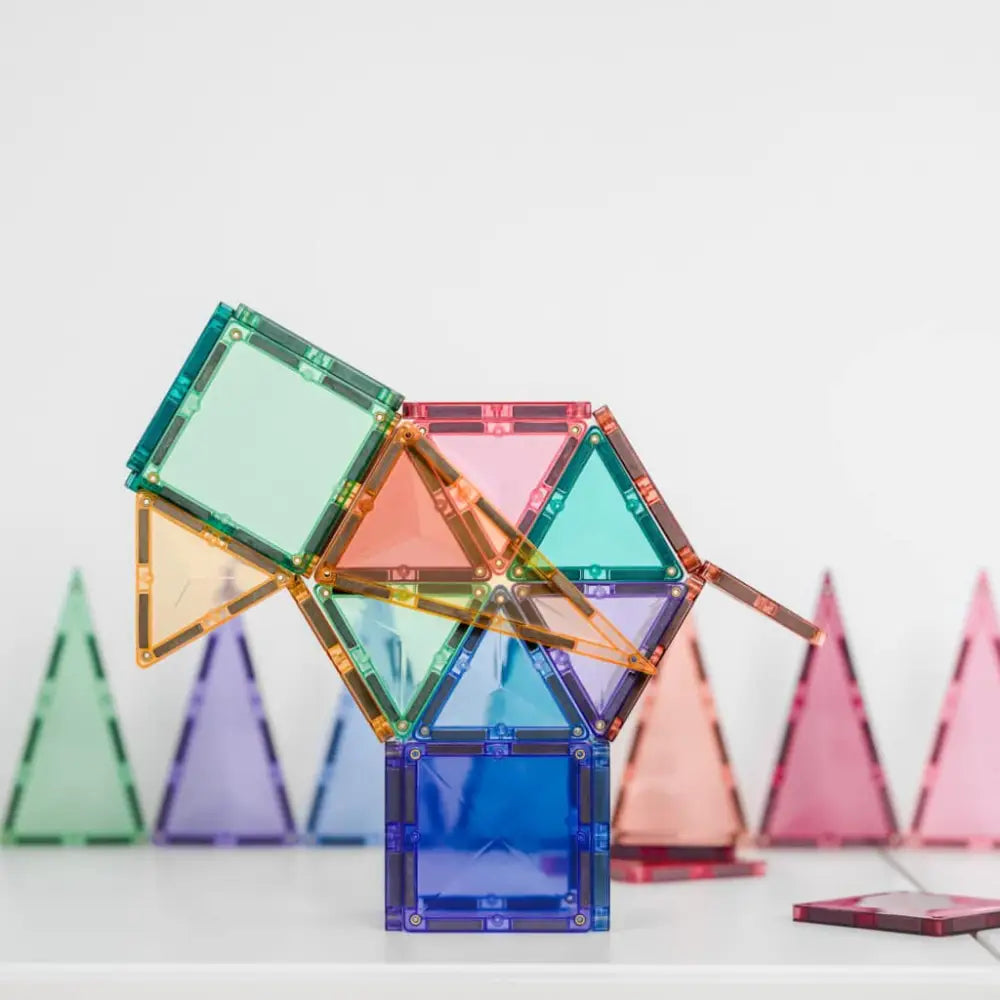 Colorful magnetic building tiles assembled into a geometric structure.