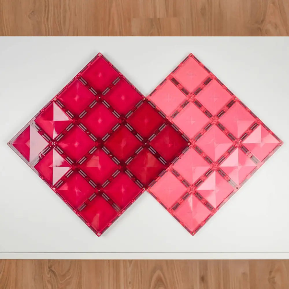 Two diamond-shaped geometric wall art pieces in shades of red and pink.