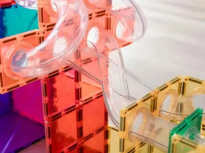 Colorful plastic construction toy set with transparent tubes and interlocking pieces.
