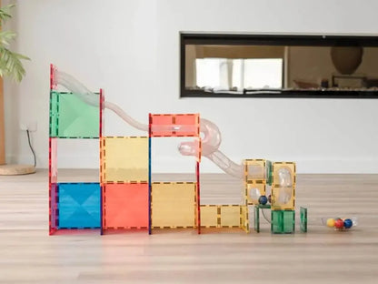 Colorful modular building blocks arranged in a playful structure with a slide.