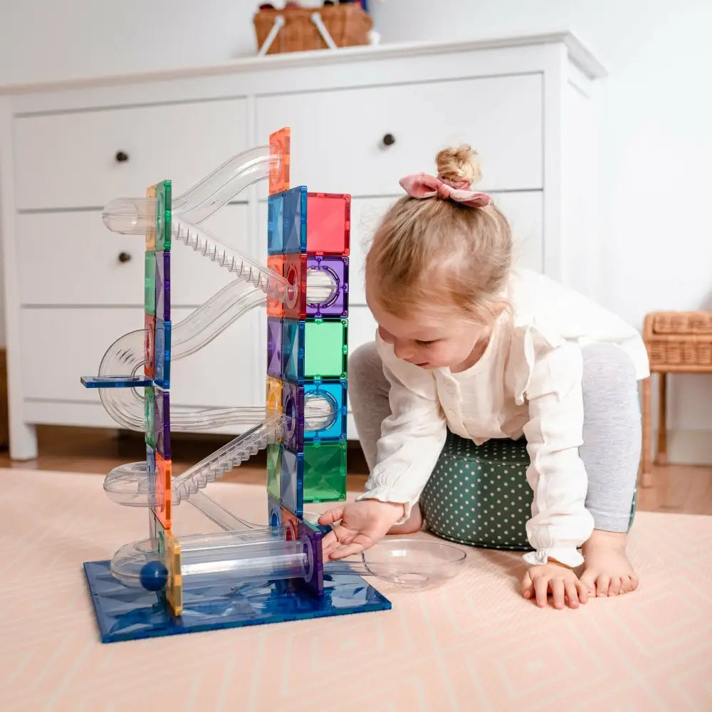 Colorful magnetic tile marble run toy with clear tubes and tracks.