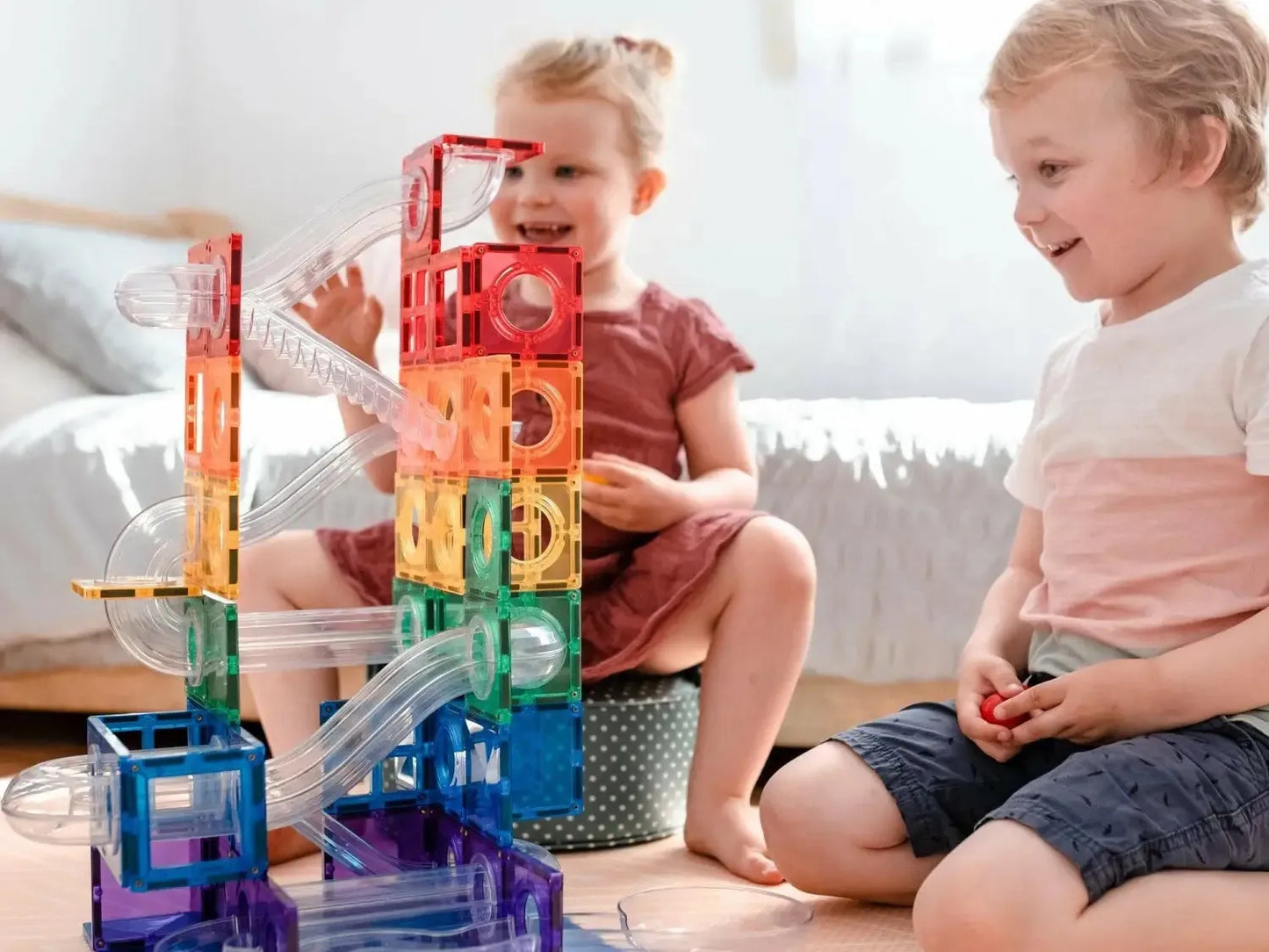 Colorful, translucent plastic marble run toy with various tracks and levels.