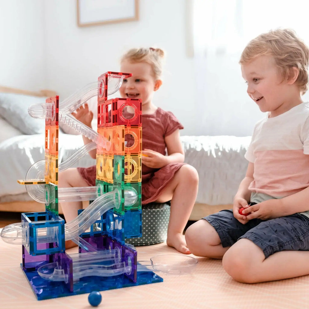 Colorful, translucent plastic marble run toy with various tracks and levels.