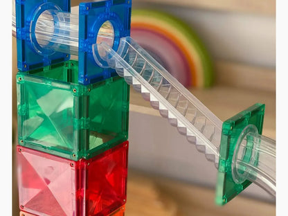 Colorful plastic building blocks with a transparent tube and staircase attachment.