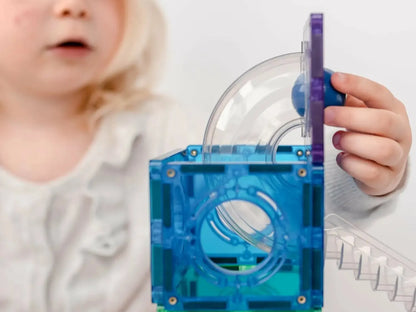 Colorful plastic toy with interconnected chambers and tubes for exploring air or ball movement.