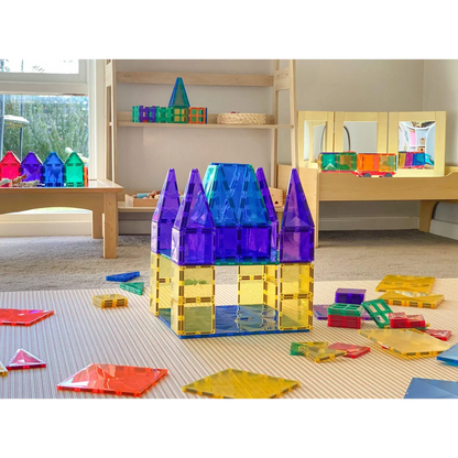 Colorful plastic building blocks assembled into a castle-like structure with purple towers.