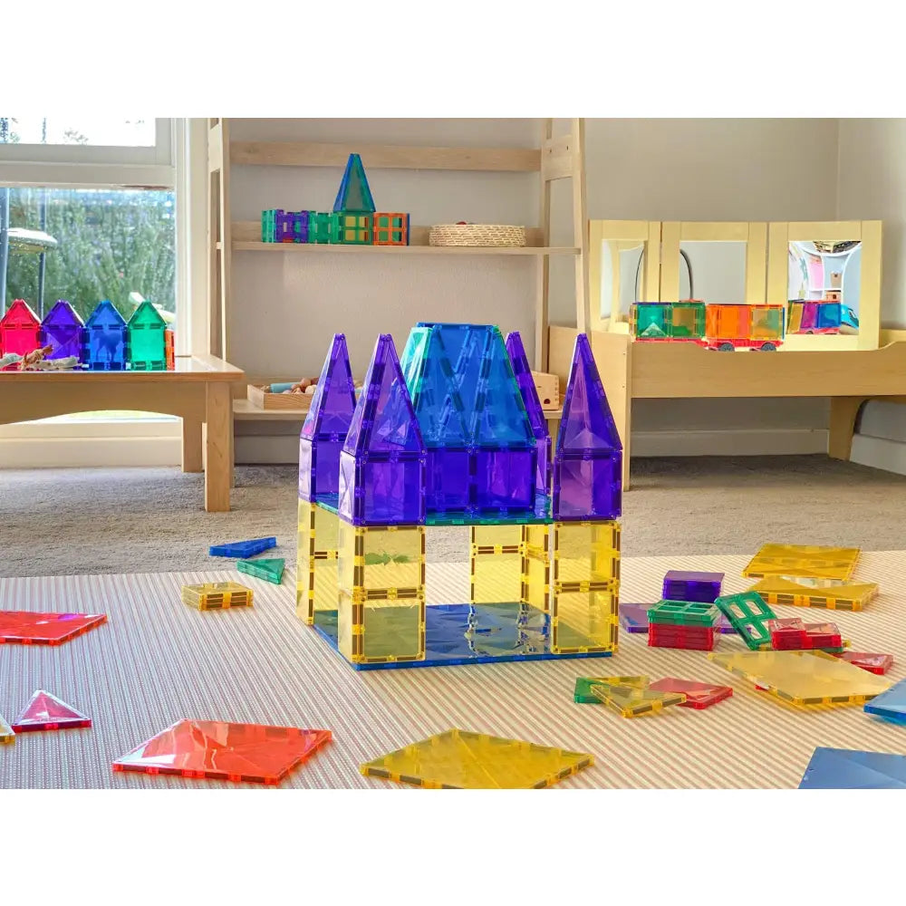 Colorful plastic building blocks assembled into a castle-like structure with purple towers.