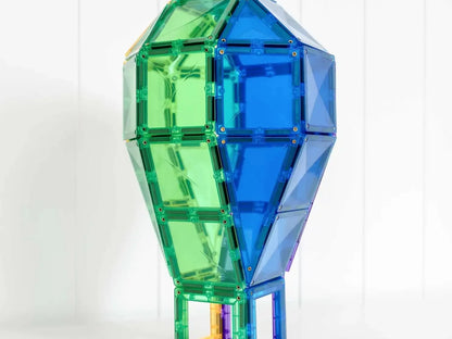 Colorful geometric light bulb-shaped structure made of translucent green and blue panels.