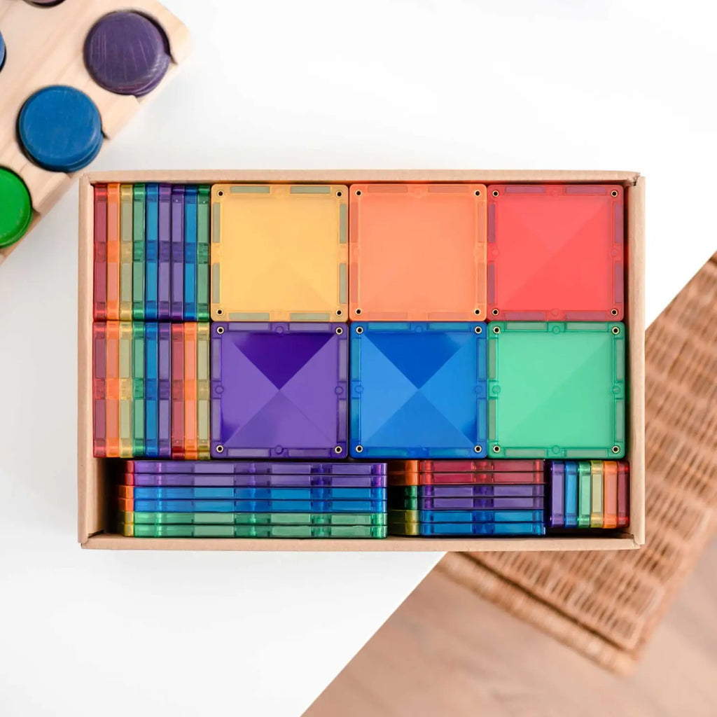 Colorful wooden geometric shape sorting toy set in a rectangular box.