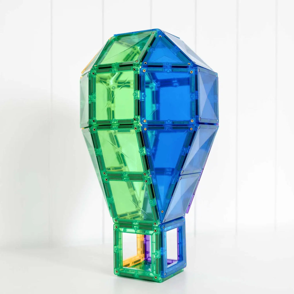 Colorful geometric light bulb-shaped structure made of translucent green and blue panels.