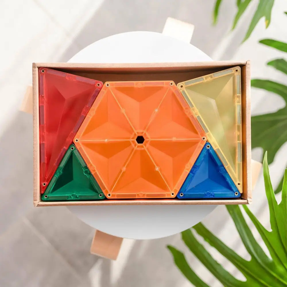 Colorful geometric puzzle or toy made of triangular and hexagonal shapes arranged in a wooden frame.