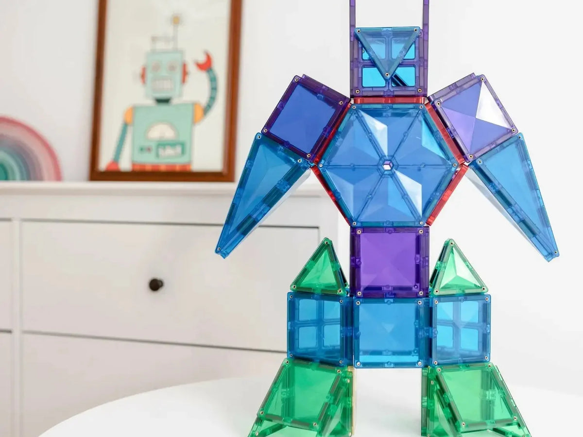 Colorful robot-like figure constructed from translucent magnetic building tiles.