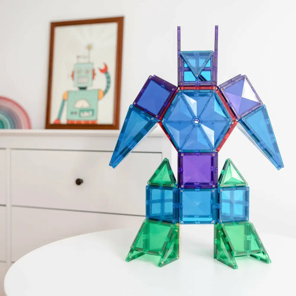 Colorful robot-like figure constructed from translucent magnetic building tiles.