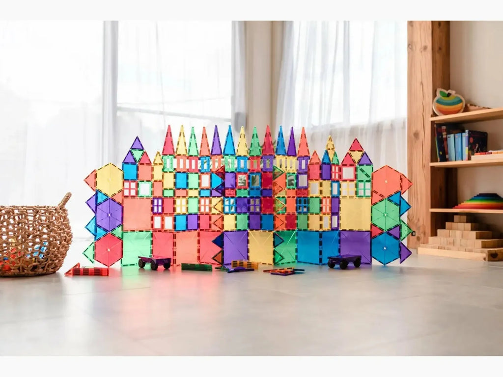 Colorful magnetic building tiles arranged into a castle-like structure.