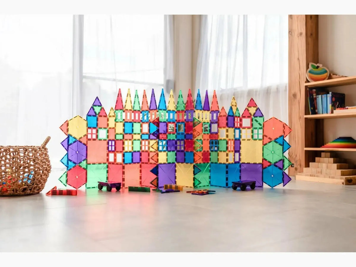Colorful magnetic building tiles arranged into a castle-like structure.
