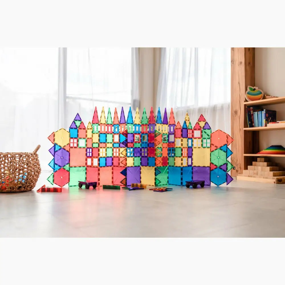 Colorful magnetic building tiles arranged into a castle-like structure.