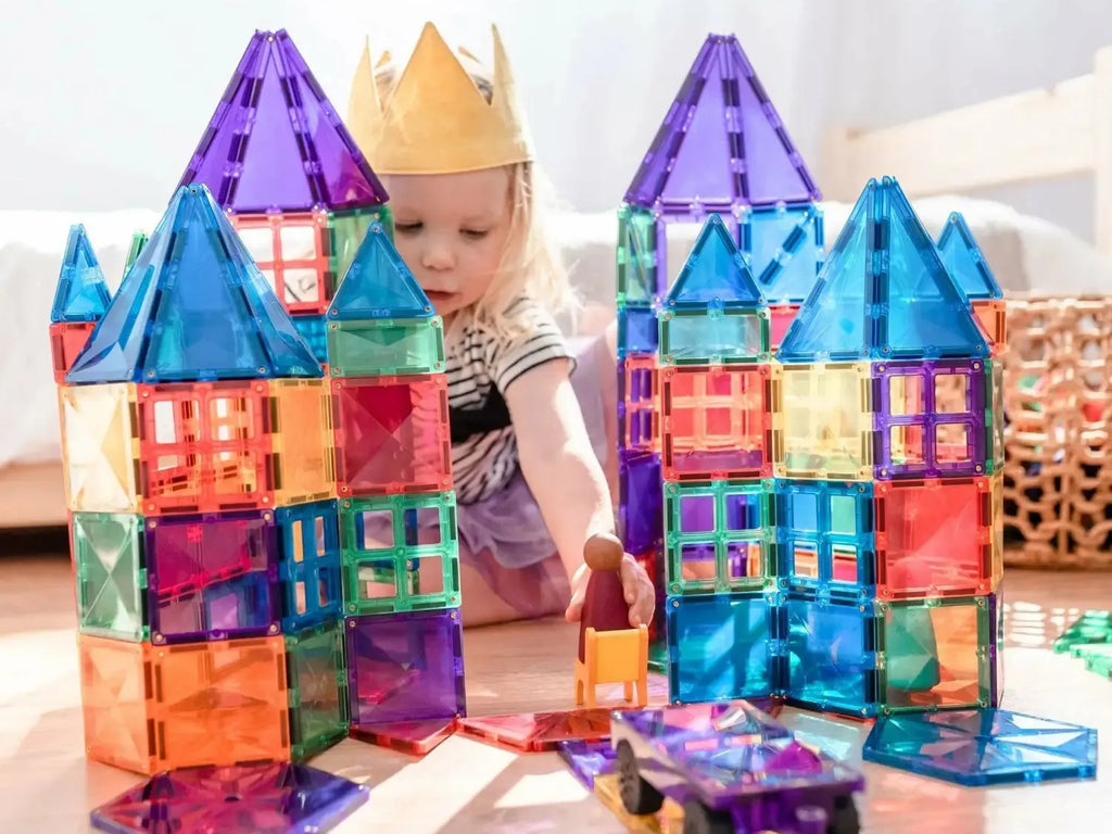 Colorful magnetic building tiles assembled into castle-like structures.