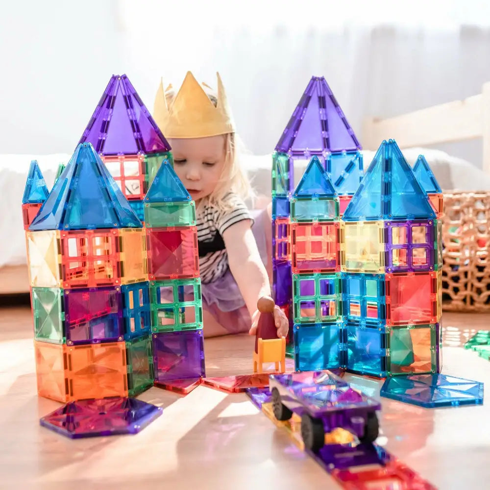 Colorful magnetic building tiles assembled into castle-like structures.