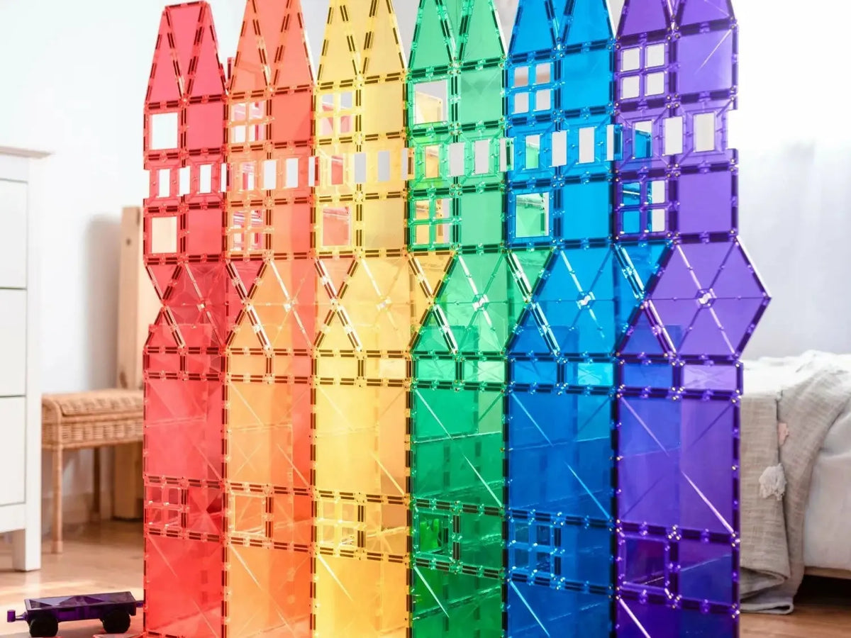 Rainbow-colored magnetic building tiles arranged in tall vertical stacks.