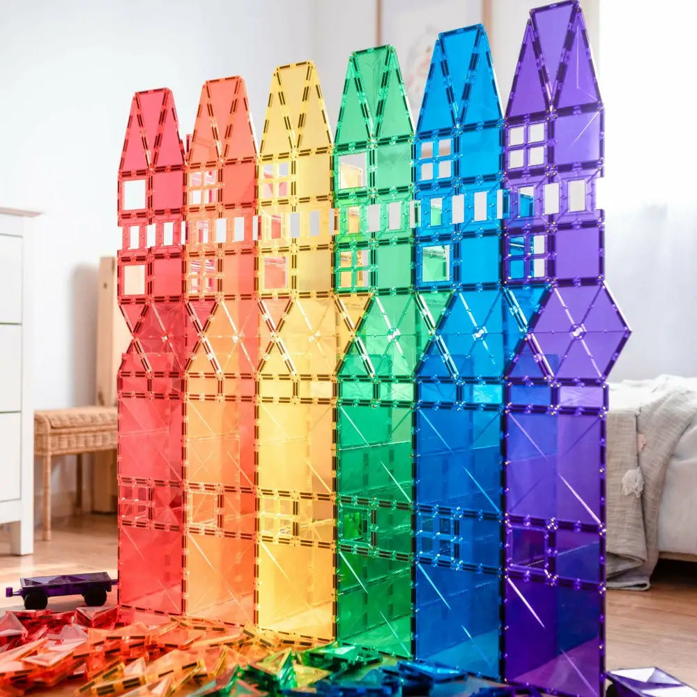 Rainbow-colored magnetic building tiles arranged in tall vertical stacks.