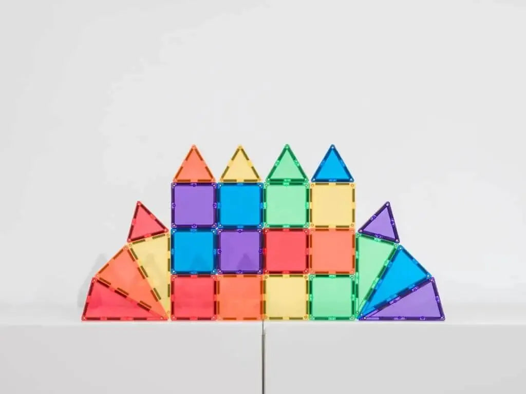 Colorful geometric construction made of magnetic tiles arranged in a symmetrical castle-like shape.